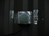 foil tape on the ground-facing side of the puck antenna can attach it to the lid and help with reception